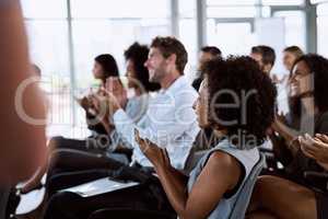 When a presentations facts make an impact. a group of businesspeople clapping during a conference.