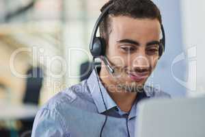 On standby to offer his best services. a young call centre agent working in an office.