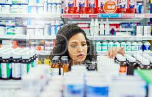Looking for the perfect remedy. a female customer in a pharmacy.
