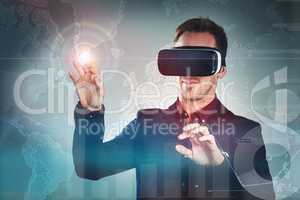 Virtual reality, the business enhancer. Studio shot of a handsome young businessman using a vr headset against a digitally imposed background.