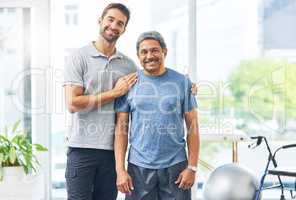 Hes my number one priority. Cropped portrait of a young male physiotherapist assisting a senior patient in recovery.