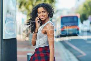 When travelling in the city, always carry a cellphone. an attractive young woman on a call in the city.