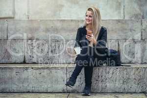 How did the generation before us survive without phones. an attractive woman using a mobile phone in the city.