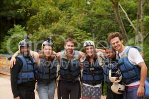 The best team to go with, on any adventure. Portrait of a group of young male friends before going white water rafting.