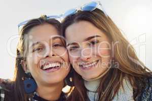 Two peas in a pod. Cropped portrait of two attractive young women spending the day outdoors.