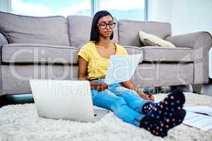 Learning financial responsibilities at a young age. a teenage girl doing schoolwork at home.