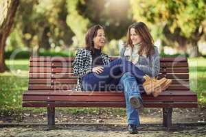 The perfect spot to chill. Full length shot of two attractive young women spending the day outdoors.