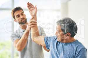 Your mobility looks good. a young male physiotherapist assisting a senior patient in recovery.