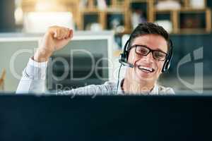 My sales have driven through the roof. Portrait of a young call centre agent cheering while working in an office.