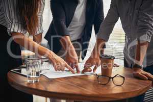 This might just bring us success sooner than we thought. unrecognizable businesspeople working on paperwork together in the office.