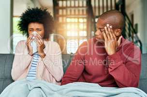 Hope your germs dont get passed on to me. a young man looking at his girlfriend suffering with allergies at home.