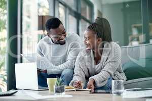 Couple planning finance investments, insurance and banking bills papers together at home. Happy husband and young wife smiling over their financial budget report information and household money plan