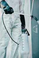 Covid pandemic outbreak cleaner and healthcare worker in protective ppe to prevent spread of virus outside. Professional in hazmat suit cleaning and disinfecting the street or building for hygiene