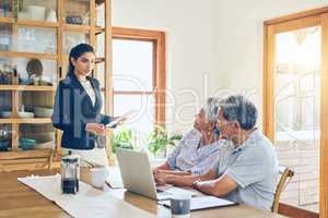 She provides the most helpful advice. a mature couple getting advice from their financial consultant at home.