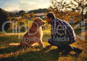 Dogs are the most loyal friends youll ever have. Full length shot of a handsome young man and his dog spending a day in the park.