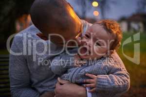 Dad knows how to calm him down. a father comforting his crying son outdoors.