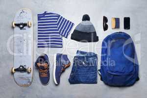 Skater boy outfit, style or fashion laid out on the floor looking edgy, trendy and fashionable with a skateboard top view. Cool, stylish and casual monochrome skateboarding clothes, equipment or gear