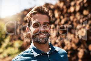 Ive got a love for lumber. Cropped portrait of a lumberjack standing in front of a pile of wood.