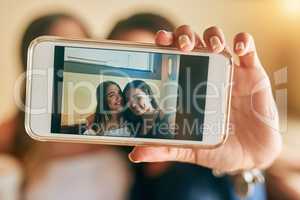 Framing their friendship. two attractive young women taking selfies in their local cafe.