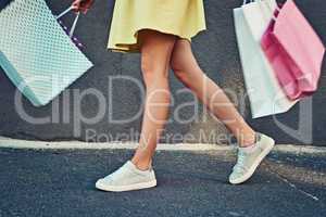Shopping but no ways Im dropping. an unrecognizable woman on a shopping spree in the city.