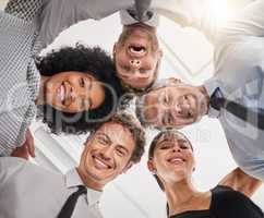 Surround yourself with ambitious minded people. Low angle portrait of a group of businesspeople huddled together in solidarity.