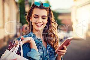 Ive got the outfits now to find the place to go. a beautiful young woman on a shopping spree in the city.