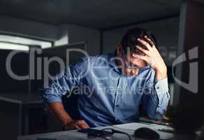 Stressed, tired business man suffering from headache, working late night in the office. Worried male entrepreneur thinking about problems and project deadline feeling burnout, distress and exhausted.