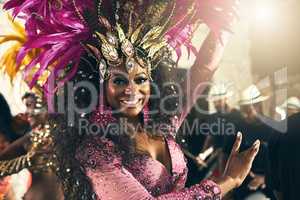Turning sound into seduction. Cropped portrait of a beautiful samba dancer performing at Carnival with her band.
