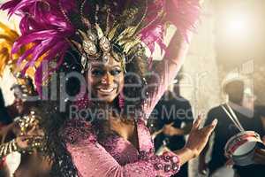 Let the beat take you away. Cropped portrait of a beautiful samba dancer performing at Carnival with her band.