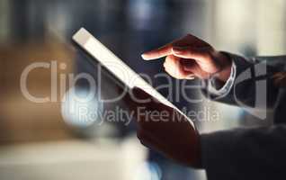 Closeup of woman reading social media news on a digital tablet while working late in an office. Professional female browsing online, researching creative plans and strategies for a business project