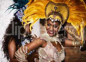 Their moves dazzle all. samba dancers performing in a carnival.