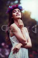 Know yourself and be her. Portrait of a beautiful young woman wearing a floral head wreath outdoors.