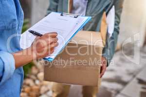 Sign to release your delivery item. Closeup shot of an unrecognizable woman signing for her delivery from the courier.