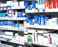 There are various brands to help beat your symptoms. shelves stocked with various medicinal products in a pharmacy.