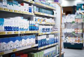 Every aisle is stocked with the health essentials you need. shelves stocked with various medicinal products in a pharmacy.