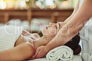 Relaxation activated. an attractive young woman getting massaged at a beauty spa.