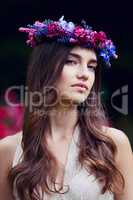 Theres a goddess inside every woman. Acknowledge her. Portrait of a beautiful young woman wearing a floral head wreath outdoors.