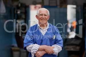 The barber shop where boys become men. Portrait of a senior man in his barber shop.