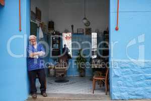 Hes been in the barber game for years. a senior man in his barber shop.