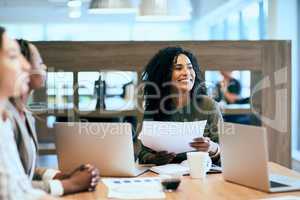 She always smiles in her work space. a group of confident young businesspeople having a meeting in the office at work during the day.