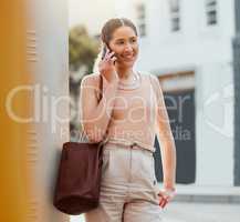 Casual woman talking on phone call, networking and making conversation while standing in the urban city alone. Trendy, smiling and cheerful female commuting and traveling to work in the morning