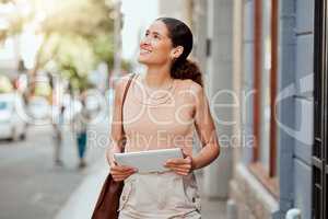 Vision, ambitious and inspired creative woman walking in an urban city holding a digital tablet. Female designer exploring, visiting and enjoying a sightseeing in a town outdoors for inspiration.
