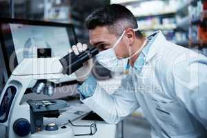 He sets the standard for excellent clinical research. a mature man using a microscope while conducting pharmaceutical research.