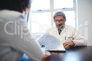 Ive complied a thorough treatment plan for you. a mature doctor having a consultation with a patient in his office.