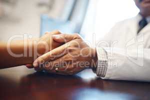 I can assure you that all will be fine. Closeup shot of an unrecognizable doctor holding a patients hand in comfort.