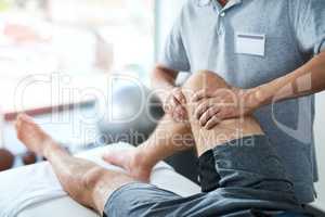 Knees require a delicate touch. an unrecognizable male physiotherapist treating a patient.