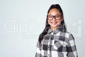 Theres a reason to smile in everyday. Studio portrait of a cute and confident young girl posing against a gray background.