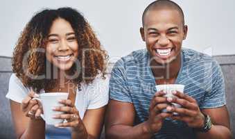 We truly are the perfect pair. Portrait of a young couple relaxing together at home.