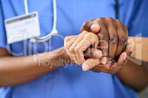 Kinds goes a long way towards healing. Closeup shot of a medical practitioner holding a patients hand in comfort.
