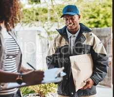 Just a signature please. a courier making a delivery to a customer at her home.